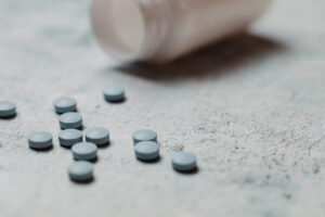 Pill bottle with pills on table