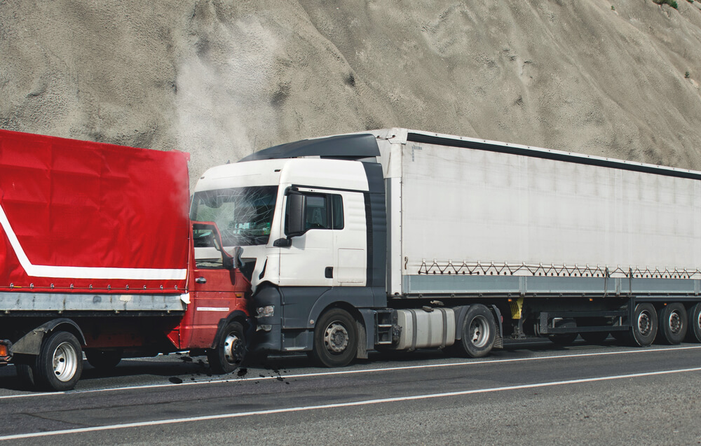 Head-on truck accident involving two commercial vehicles on a highway in Greensboro, NC